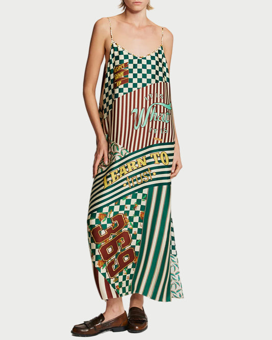 Woman wearing a colorful patterned dress on a plain background