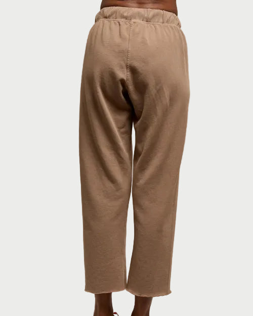 Beige wide-leg pants worn by a person on a plain background