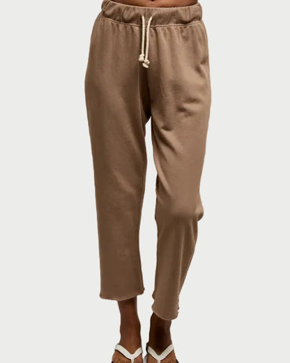 Beige sweatpants worn by a person on a plain background