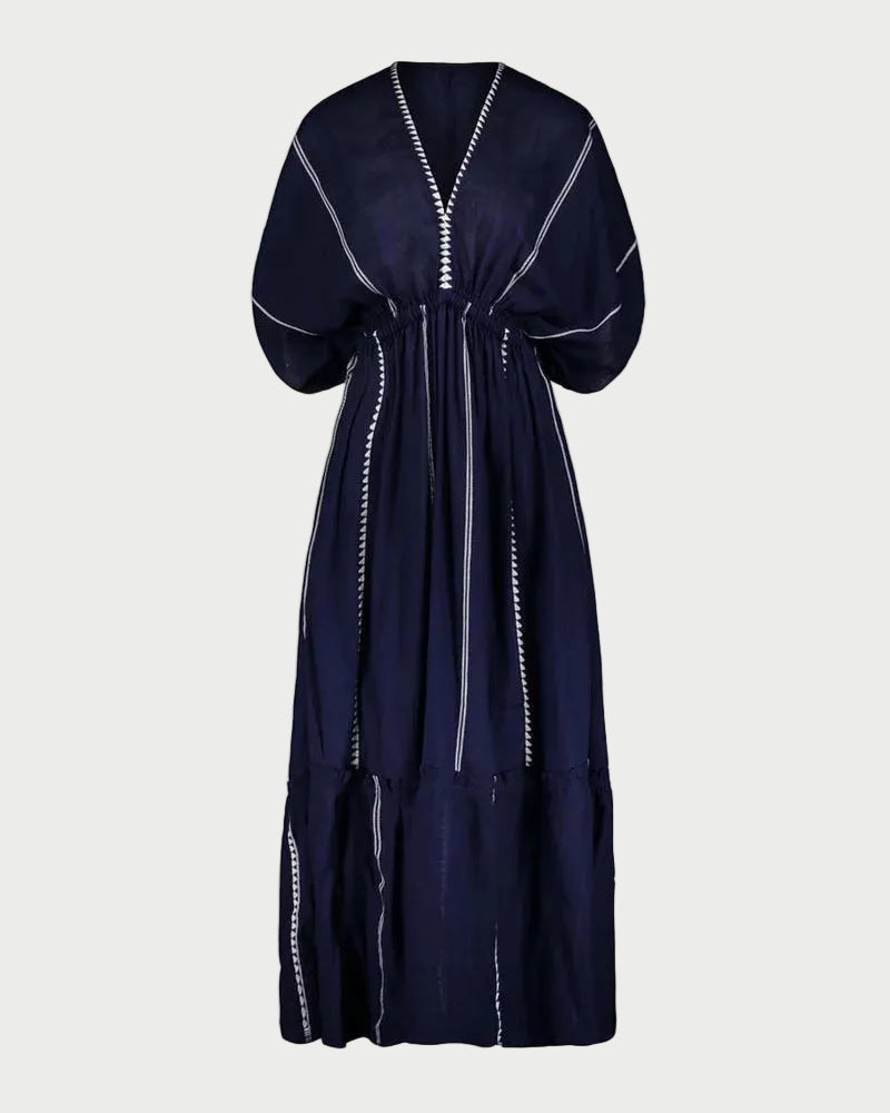Navy blue dress with white trim on a light gray background