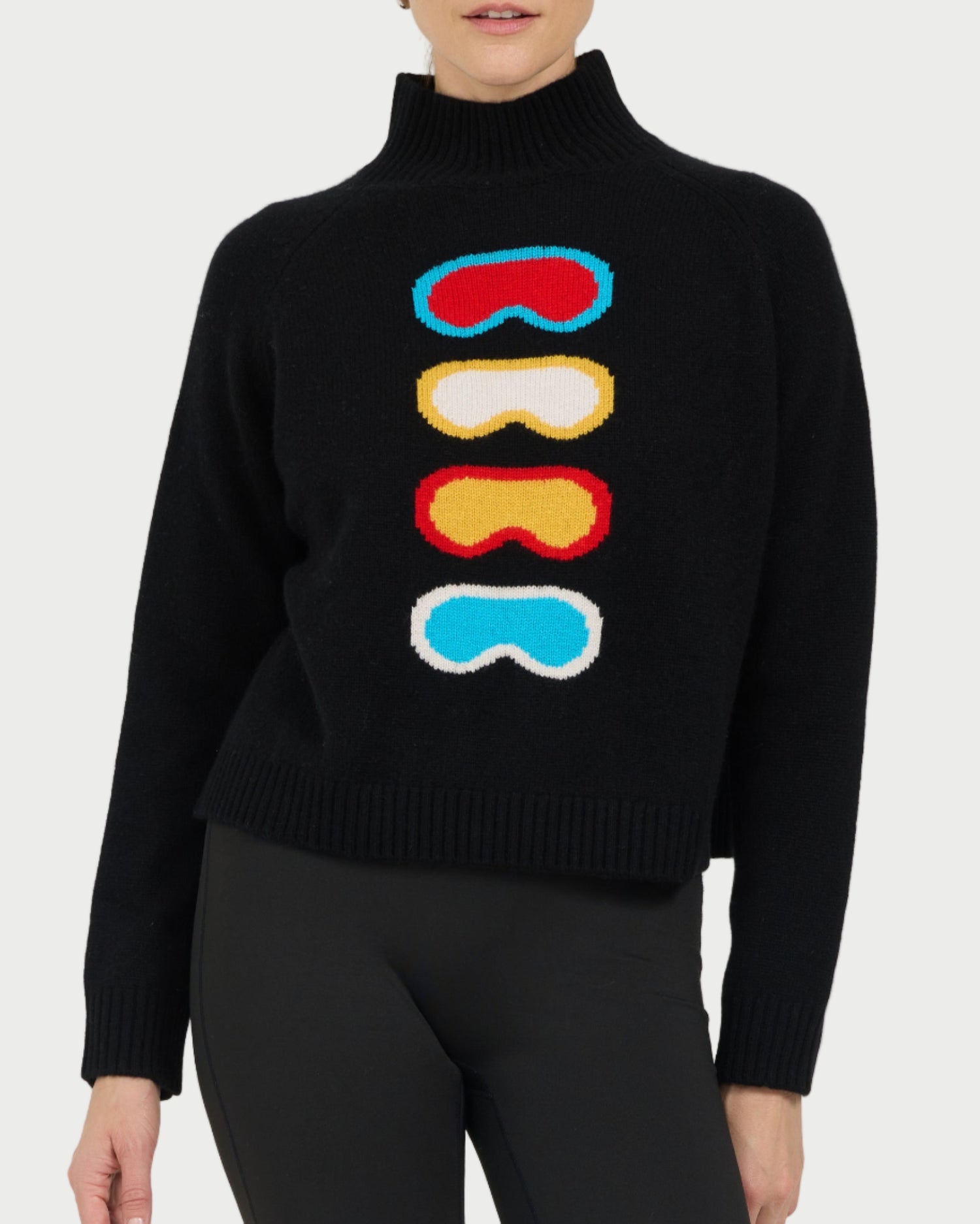 Black sweater with colorful goggles design worn by a model on a white background