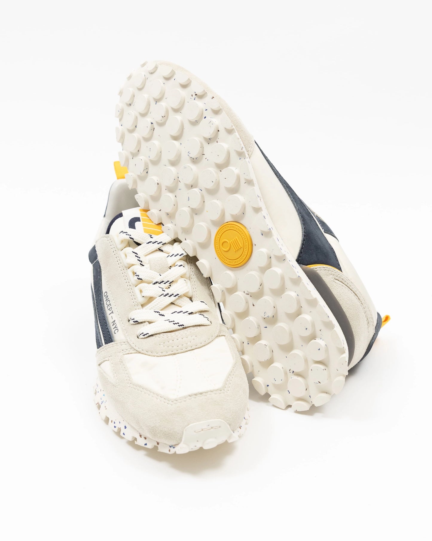 White sneakers with textured sole on a white background