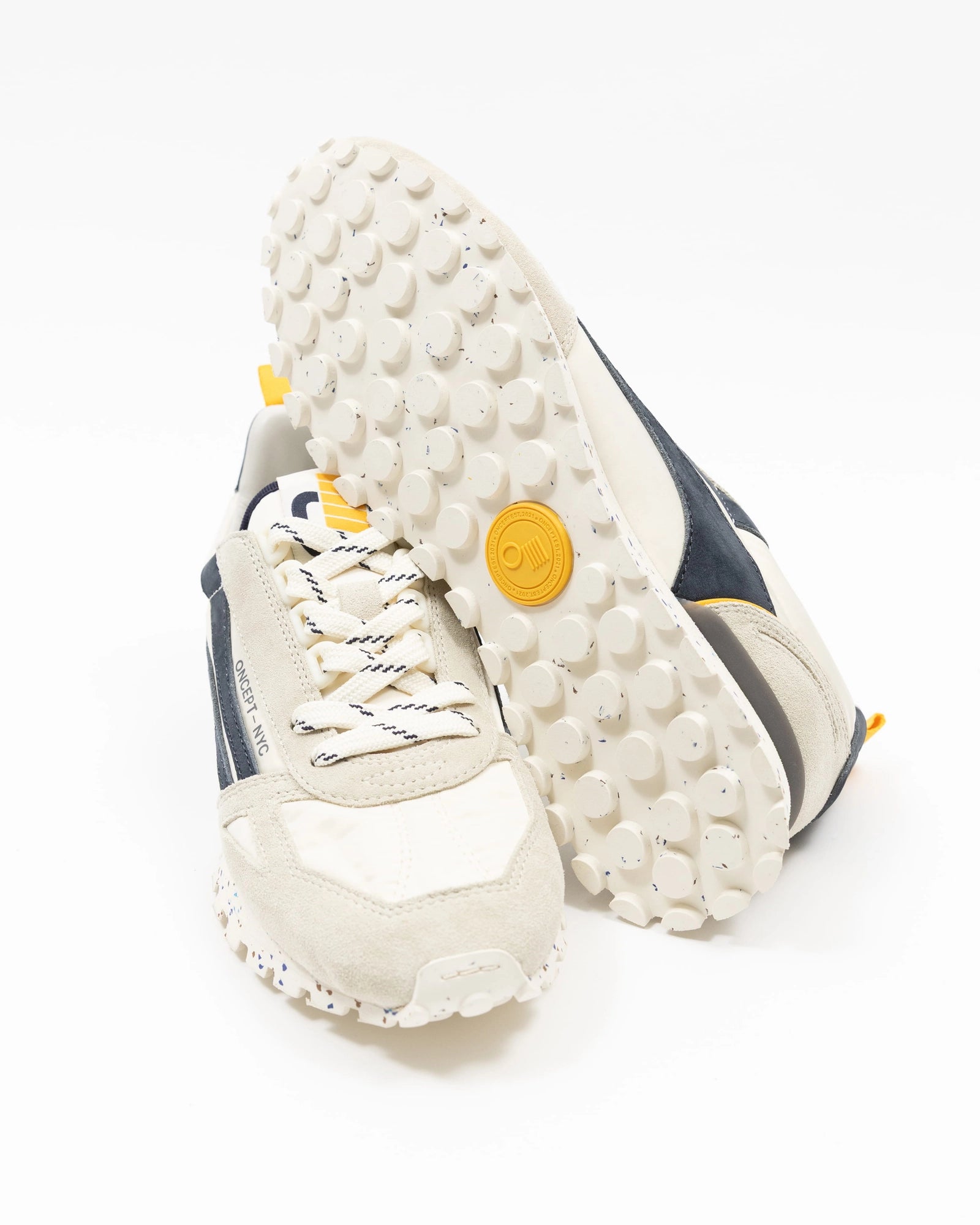 White sneakers with textured sole on a white background