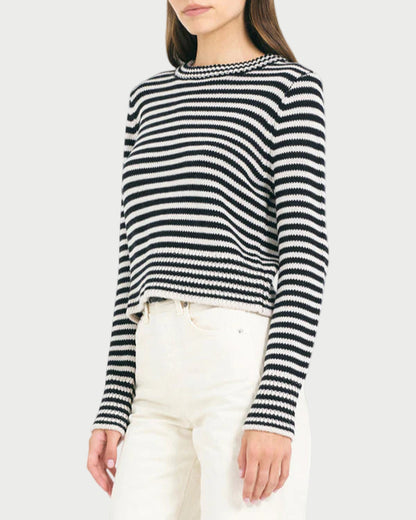Woman wearing a black and white striped sweater on a white background