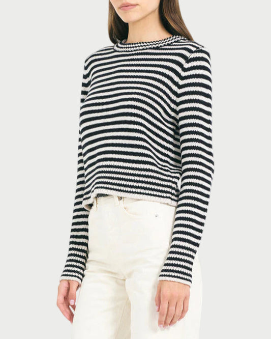 Woman wearing a black and white striped sweater on a white background