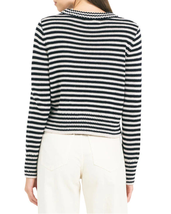 Woman wearing a black and white striped sweater on a white background