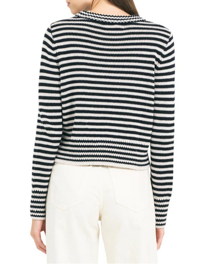 Woman wearing a black and white striped sweater on a white background