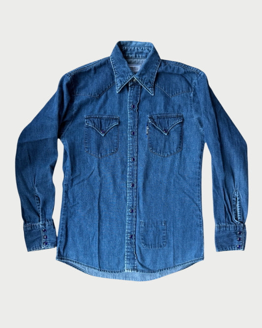 The A Friend Made Western Denim Shirt features long sleeves, a pointed collar, button-down front, and two chest pockets—showcased flat on white, it exemplifies classic American casual style.