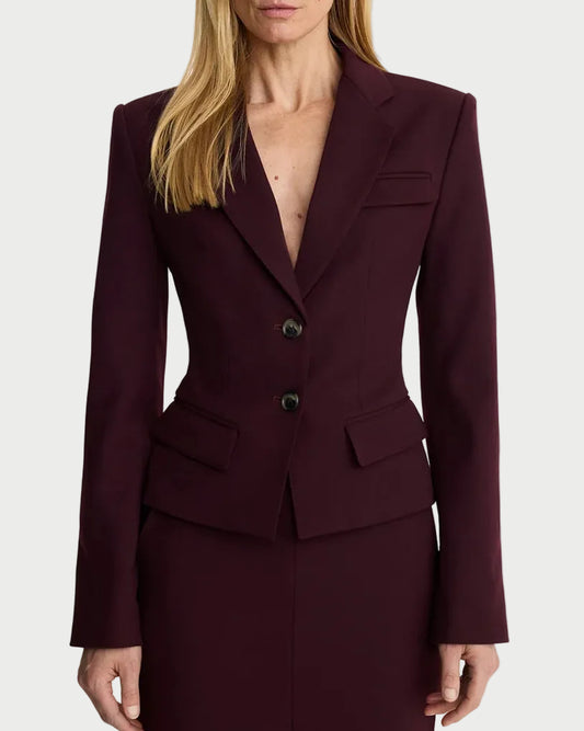 Woman wearing a burgundy suit with a plain background