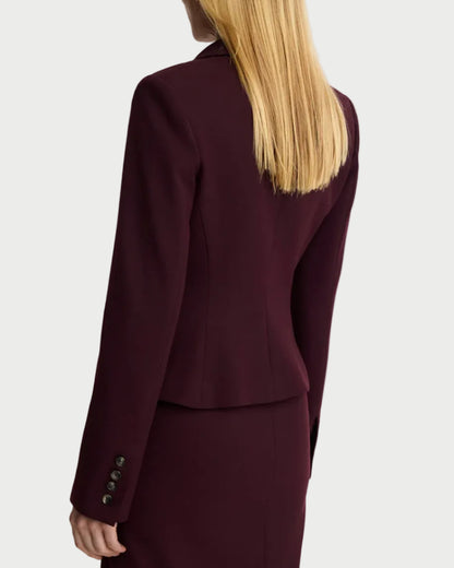 Person wearing a burgundy suit on a white background