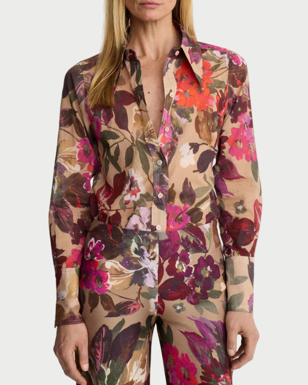 Woman wearing a floral patterned outfit on a white background