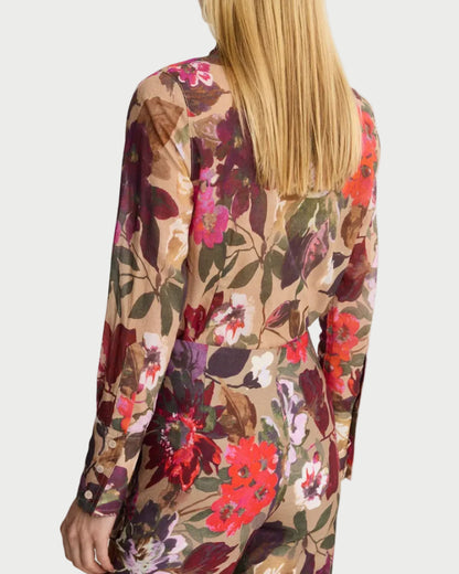 Person wearing a floral patterned outfit on a white background