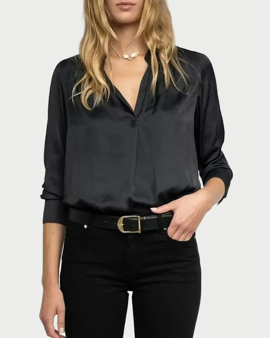 Woman wearing a black blouse and black pants on a white background