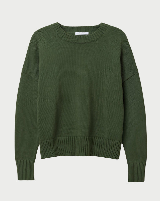 The Perfectwhitetee Green Janet Sweater by perfectwhitetee is a 100% cotton, boxy-fit sweater in dark green with long sleeves, round neckline, and ribbed cuffs, hem, and collar—shown on a white background.