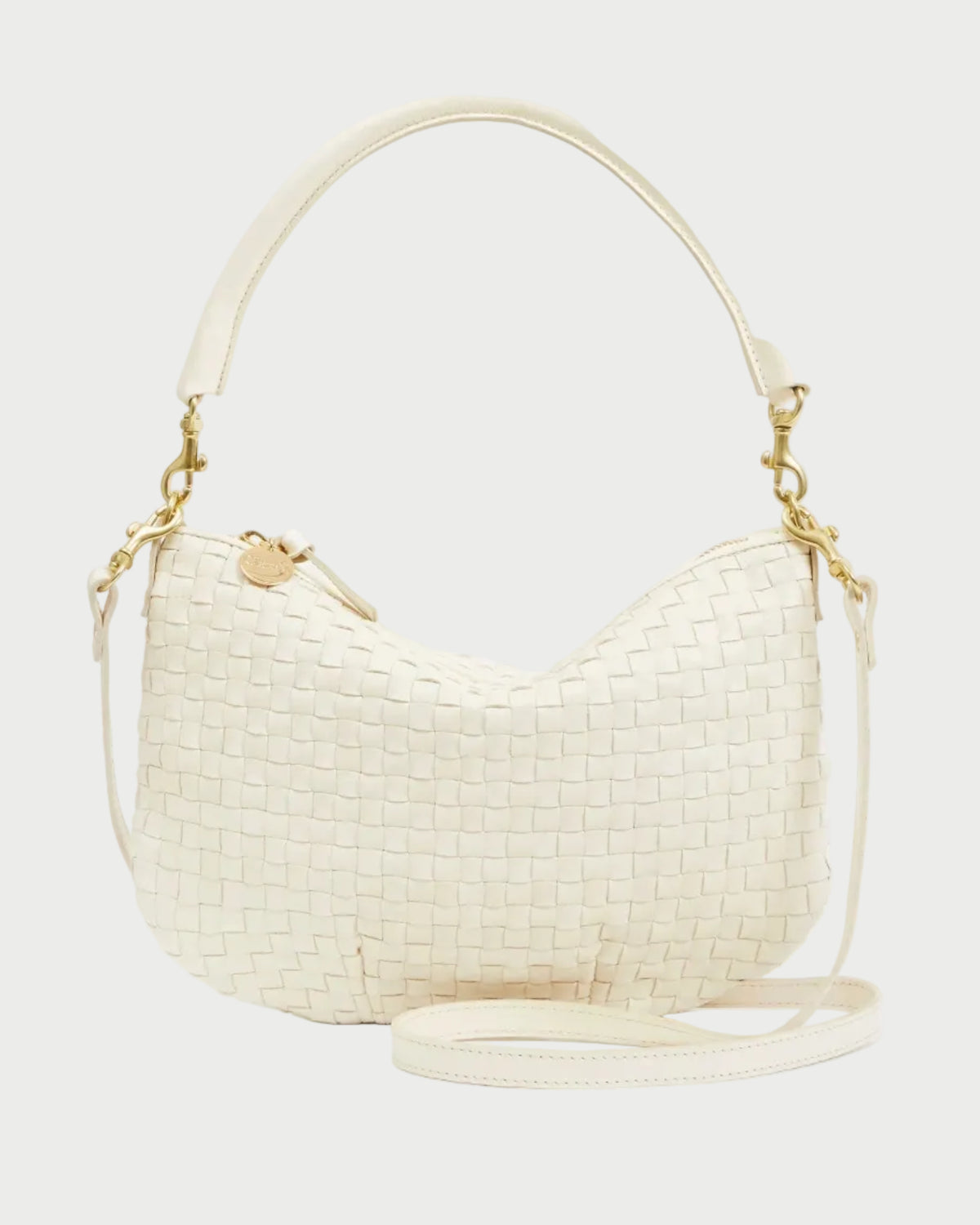Cream-colored woven handbag with gold accents on a white background