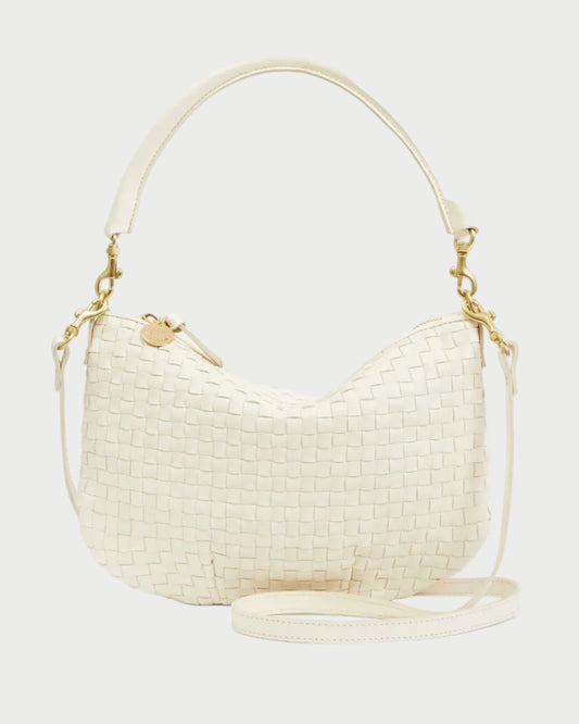 Cream-colored woven handbag with gold accents on a white background