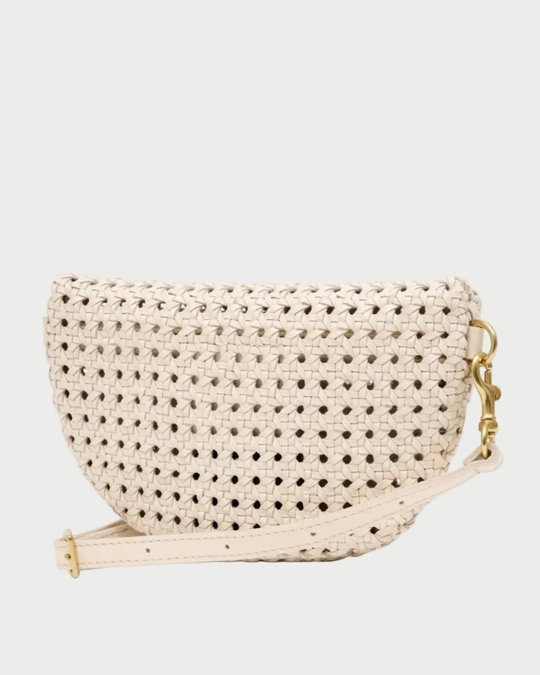 The CLARE V. Clare V. Petite Fanny Rattan is a small, half-moon shaped handwoven leather bag in beige, featuring a matching adjustable strap and elegant gold hardware, displayed on a plain white background.