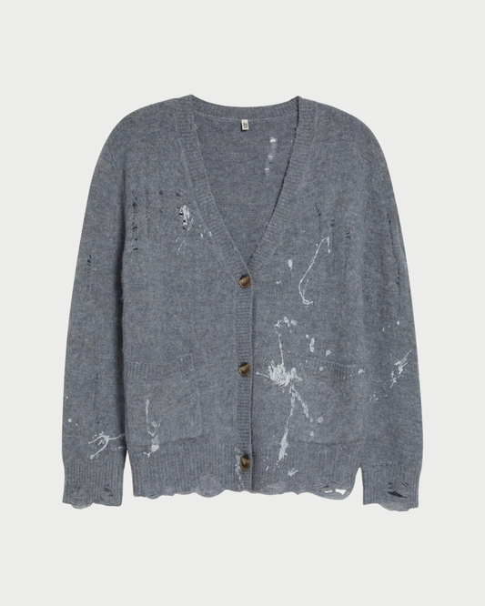 The R13 Boy Cardigan by R13 features a gray distressed finish with visible white paint splatters, distressed holes, three brown buttons, and front pockets for a worn, vintage look.