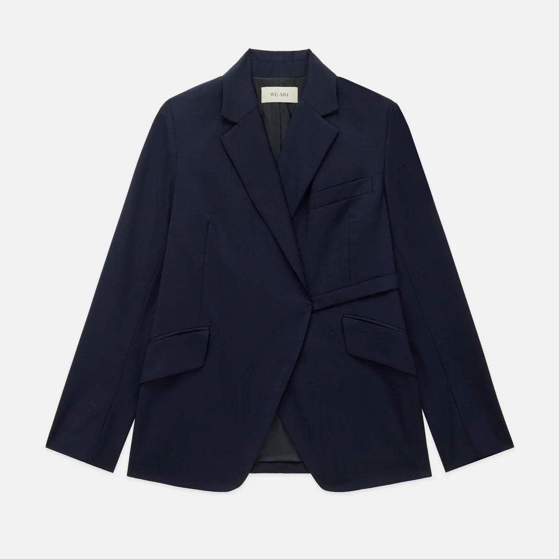 The WE-AR4 Smoking Blazer by WE-AR4 is a dark navy sustainable blazer with notch lapels, two flap pockets, a chest pocket, and a single-breasted design, crafted from upcycled virgin wool and shown laid flat on a white background.