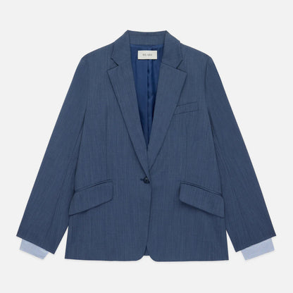 Blue pinstripe blazer on a light gray background