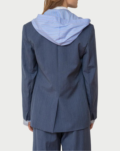 Person wearing a blue raincoat with a hood against a white background