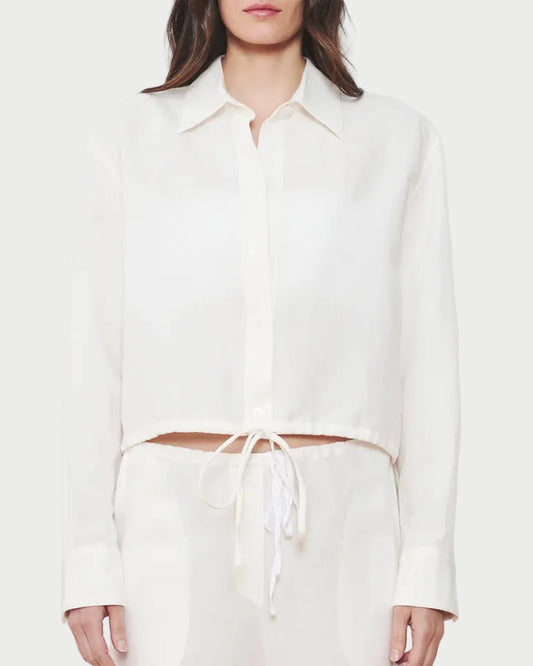 Woman wearing a white outfit on a plain background