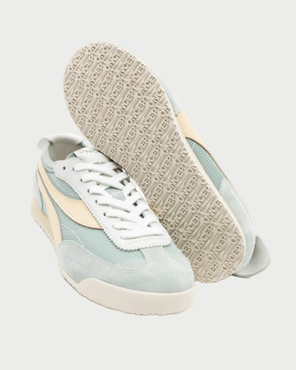 A pair of Oncept Reno Sneakers by Oncept in light blue and cream with white laces. These retro running shoes have beige soles stamped with “POWER,” shown against a plain light background.