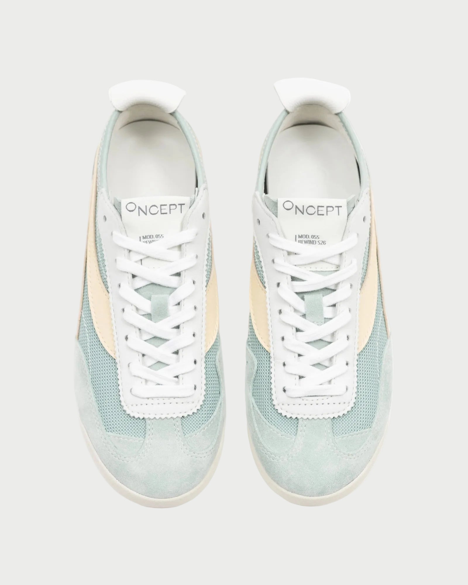 A top-down view of a pair of Oncept Reno Sneakers in light blue and beige, featuring white soles and the "Oncept" brand visible on each tongue. Inspired by retro running designs, these sneakers are lightweight and stylish.