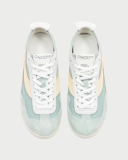 A top-down view of a pair of Oncept Reno Sneakers in light blue and beige, featuring white soles and the "Oncept" brand visible on each tongue. Inspired by retro running designs, these sneakers are lightweight and stylish.