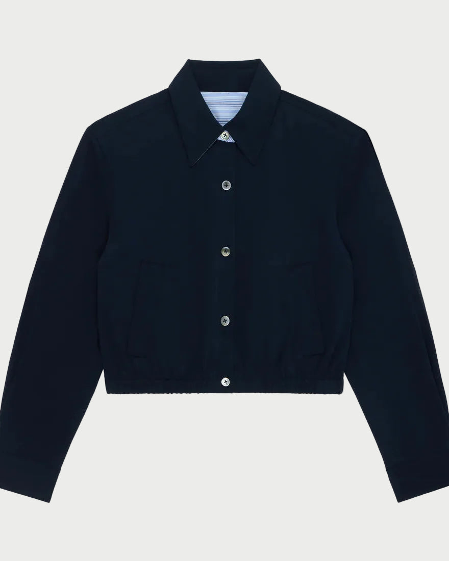 Navy blue jacket with button details on a light gray background
