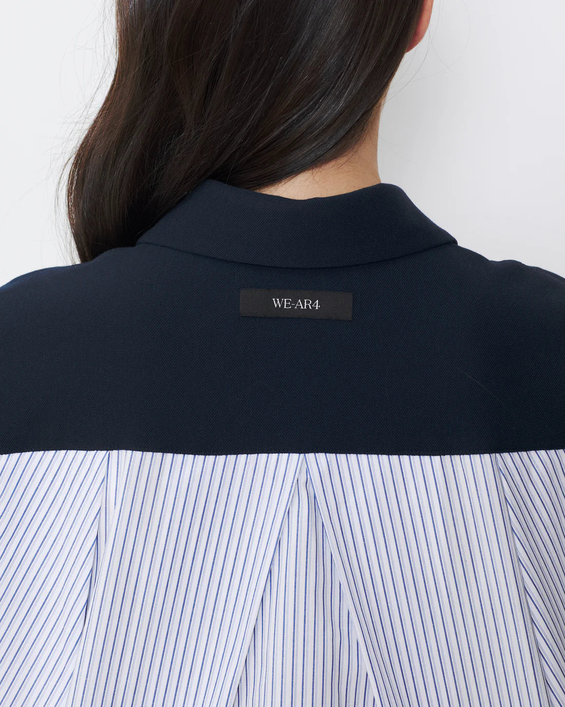 Navy shirt with a visible brand label on a white background