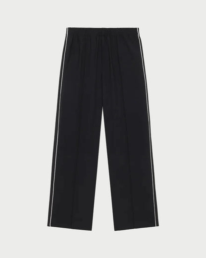 Black wide-leg cropped pants with white double stripes down the sides, shown flat against a light gray background.