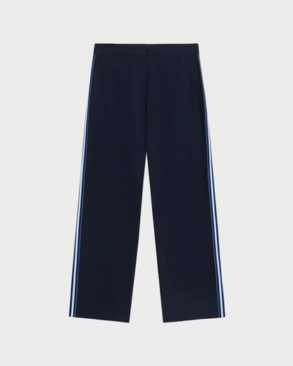 Navy pants with white stripes on a light gray background