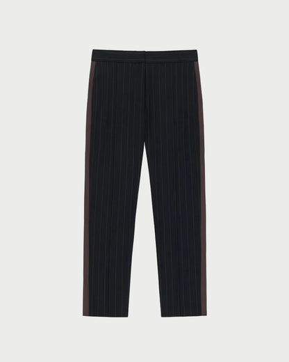 The WE-AR4 Windsor Trouser by WE-AR4 showcases black pinstripes and dark brown side panels in a tapered straight-leg silhouette, crafted from upcycled wool and laid flat on a white background—these limited edition trousers embody both sustainability and timeless style.
