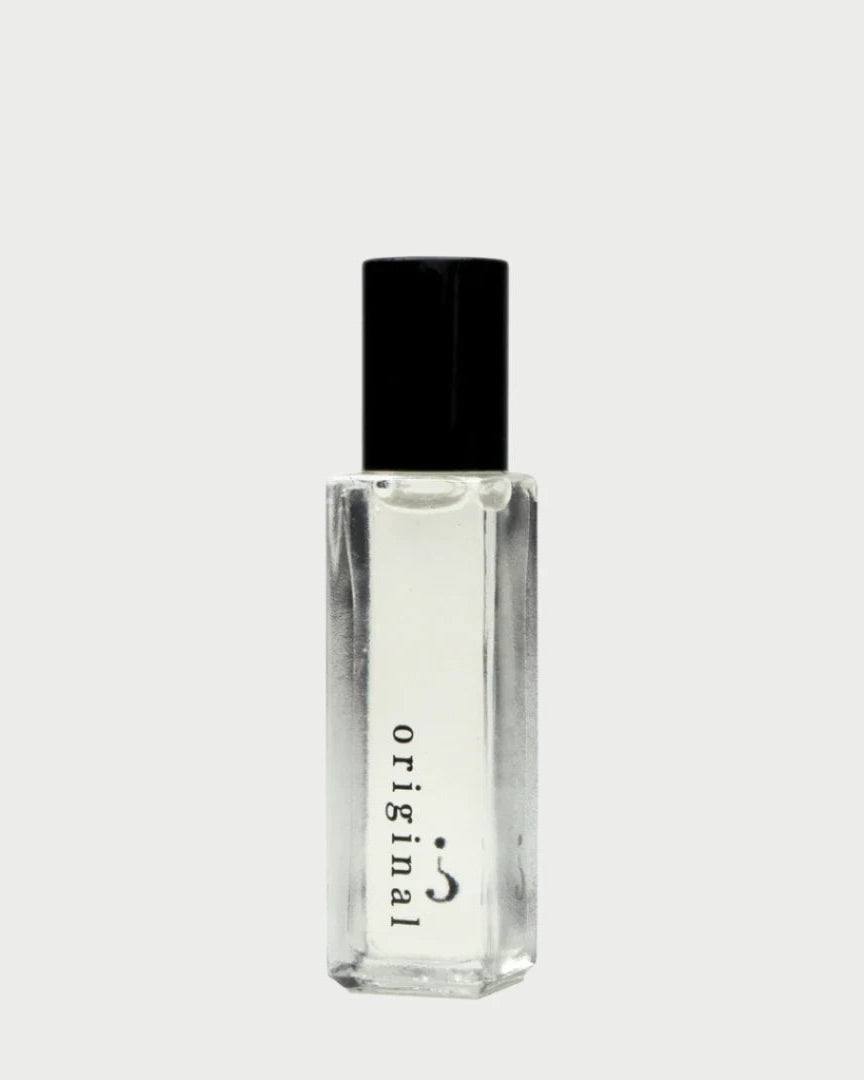 The Riddle Oil 8ml: Original by Riddle Oil is presented in a transparent bottle with a black cap, emanating a natural scent. The word "Original" is printed vertically on the front, underscoring its cult following. Set against a plain white background, its elegance and allure are unmistakable.