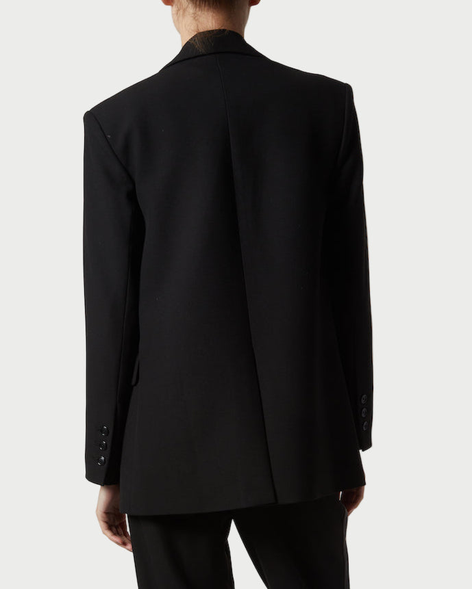 Person wearing a black suit on a white background