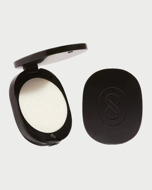 SIDIA Solid Perfume in Braless comes in a sleek black compact case with an embossed "S" on the lid. Shown open and closed, it’s perfect for carrying your favorite SIDIA fragrance on the go.