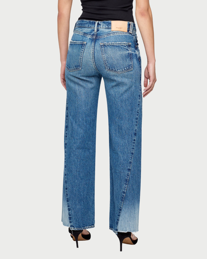 Blue jeans worn by a person on a white background