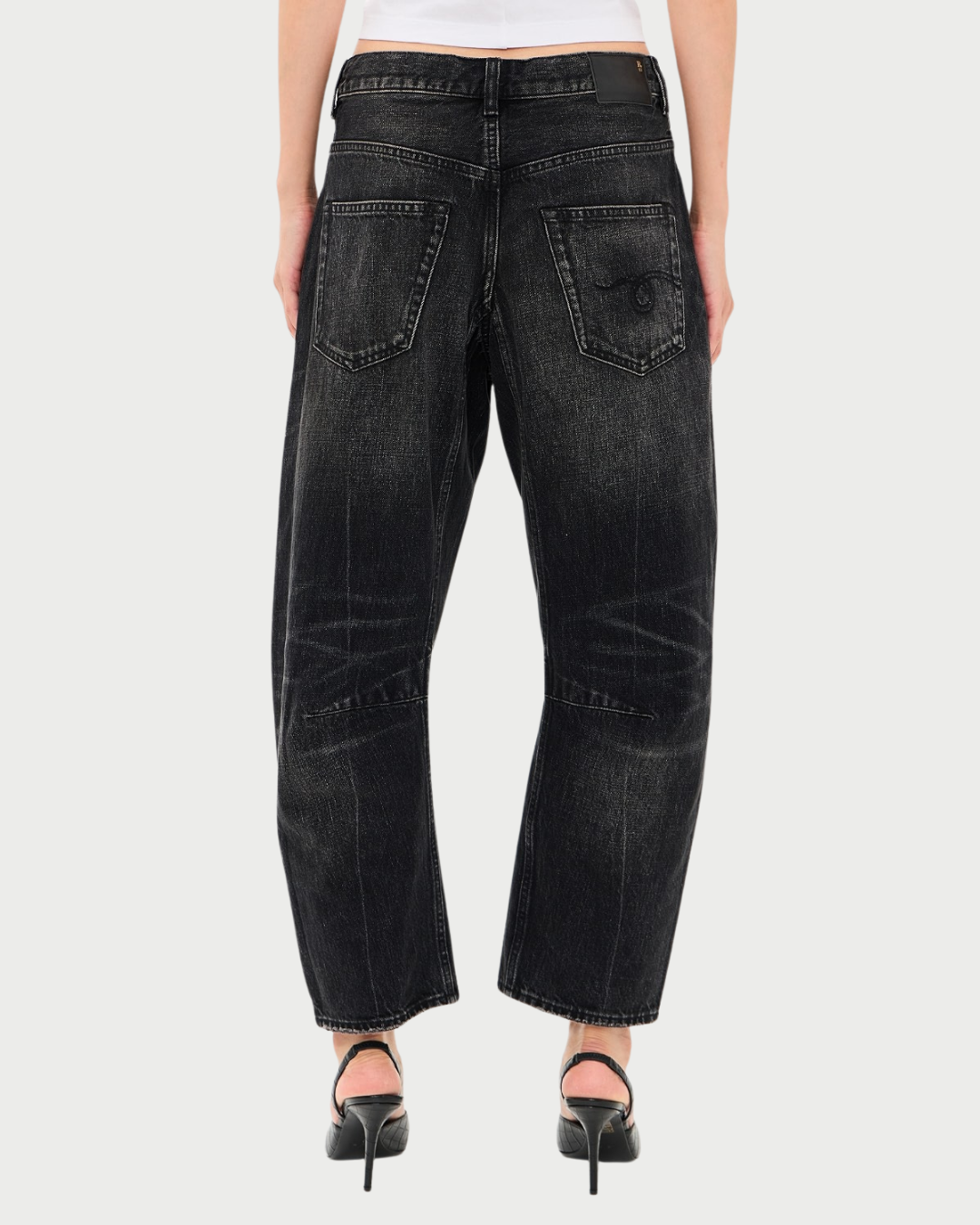 Back view of black Japanese selvedge denim R13 Articulated Knee X-BF jeans with a wide-leg, curved silhouette and articulated knee stitching.