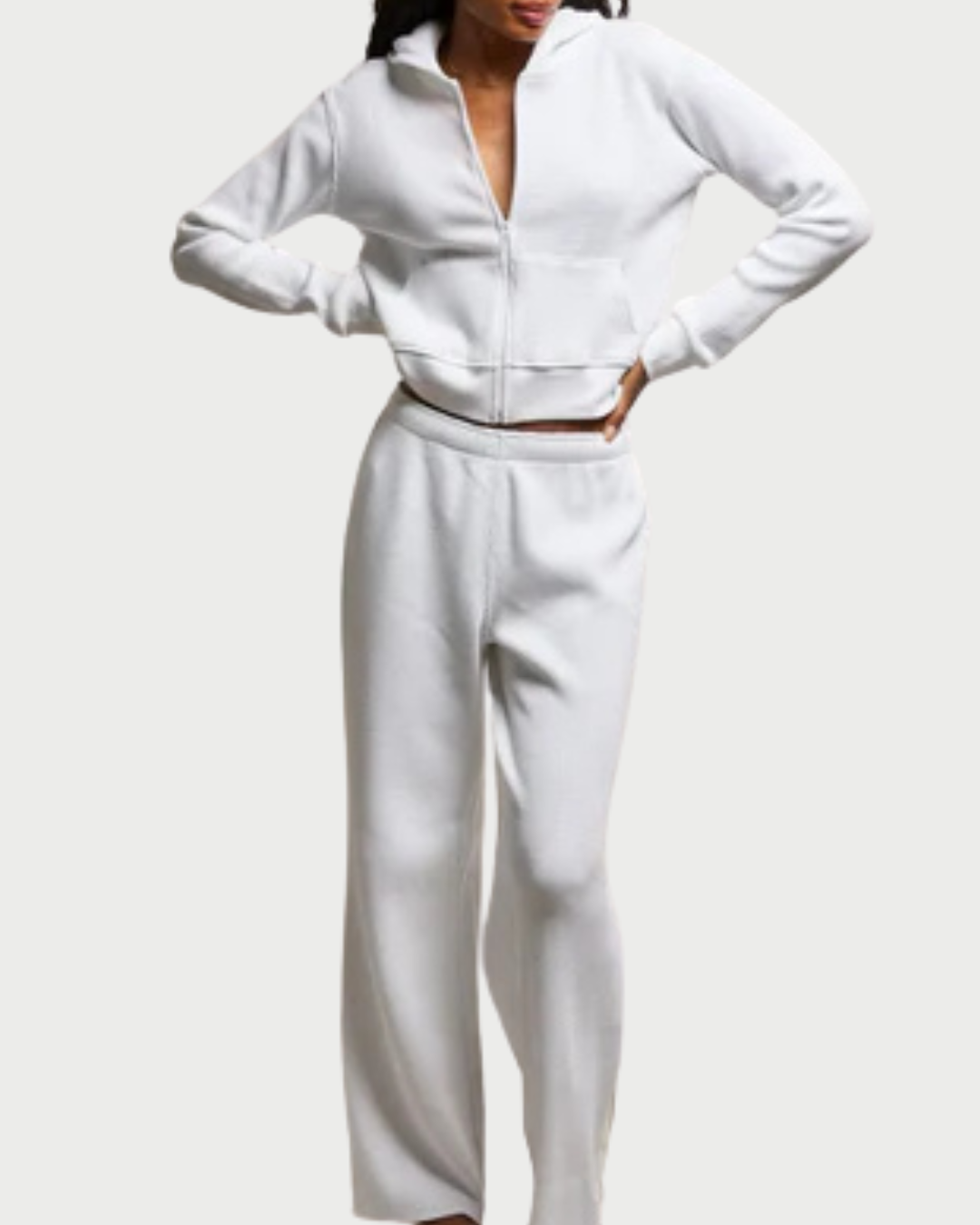 Person wearing a white outfit on a plain background
