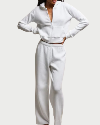Person wearing a white outfit on a plain background