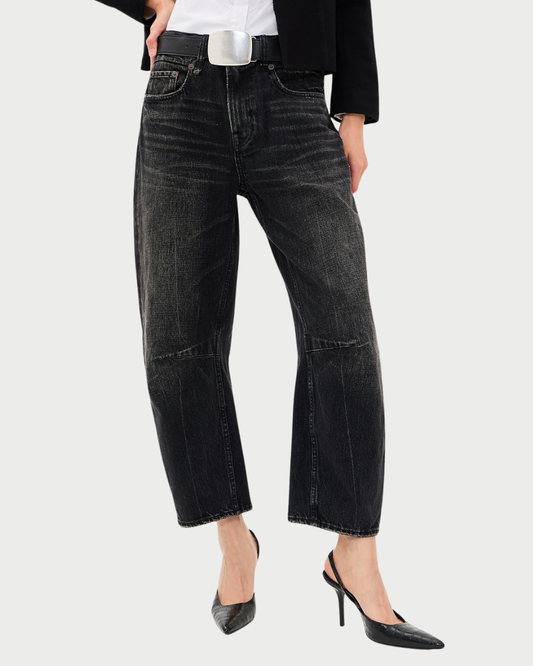 R13 Articulated Knee X-BF relaxed boyfriend fit jeans in black denim with articulated knee seams, worn with a black blazer and black stiletto pumps.