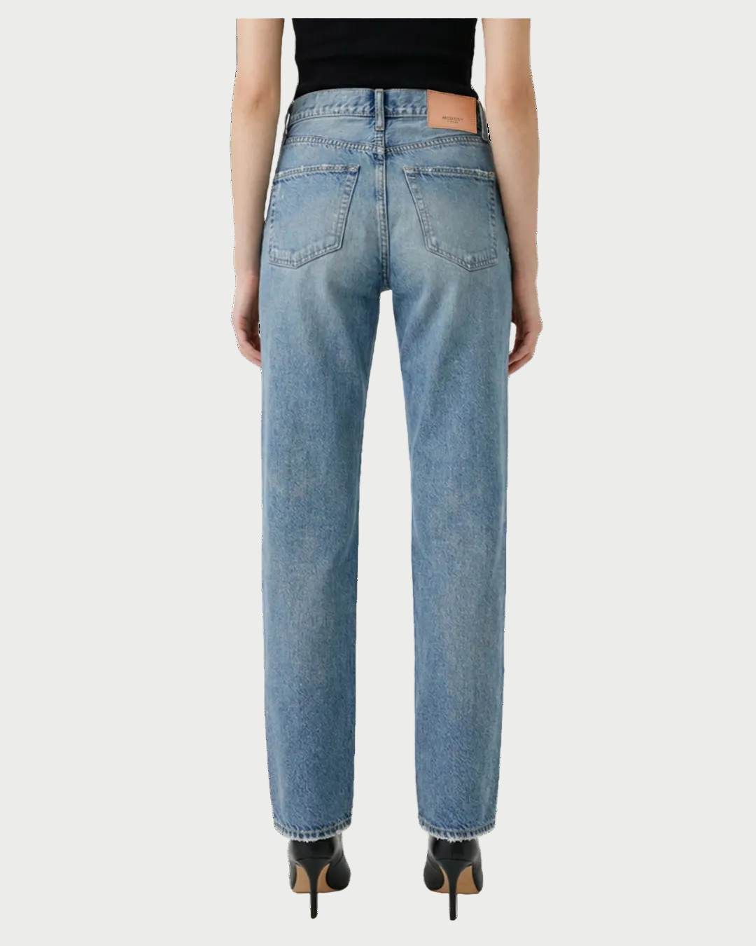 A person is seen from the back wearing Moussy Leyden Straight Jeans by Moussy, made from lightweight denim, paired with black heeled shoes and relaxed arms at their sides, set against a white background.