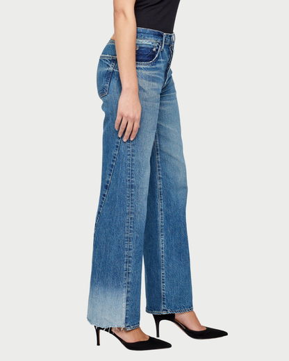 Person wearing blue jeans on a white background