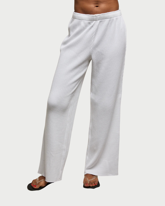 White wide-leg pants worn by a person on a white background