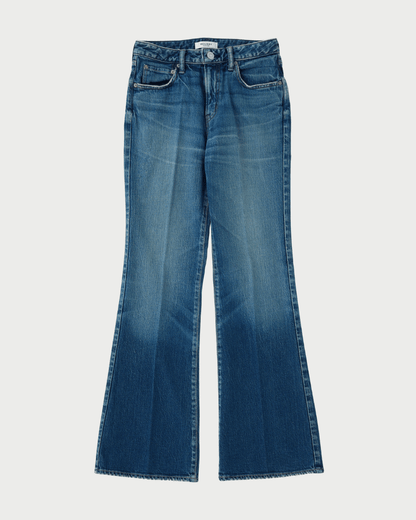 A pair of medium-wash blue denim jeans with a flared bootcut silhouette, shown flat against a light gray background.