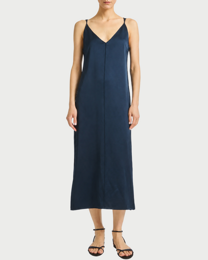 Navy slip dress worn by a model on a white background
