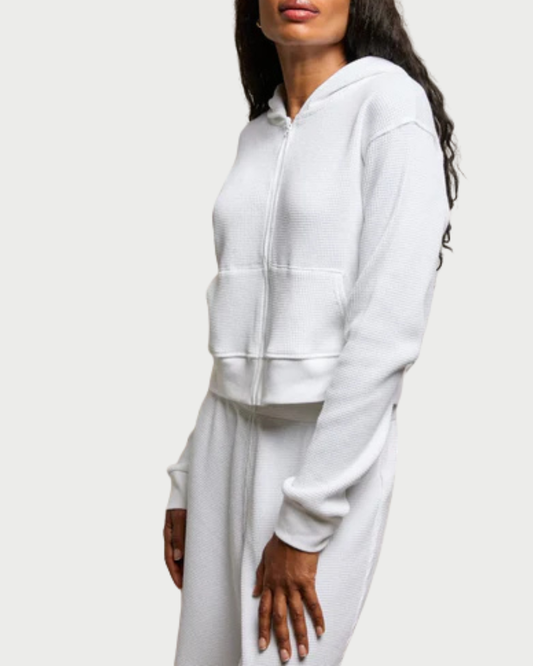 White hoodie worn by a person on a white background