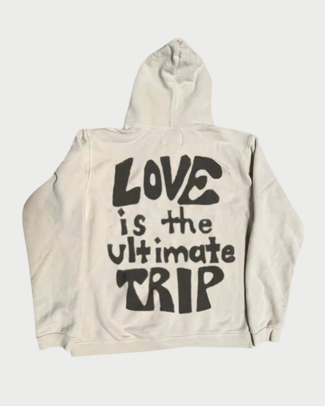 The Madeworn "Love Trip" Zip Up Hoodie features the phrase "LOVE is the ultimate TRIP" in bold black on the back, light coloring, and subtle psychedelic graphics for a standout style.