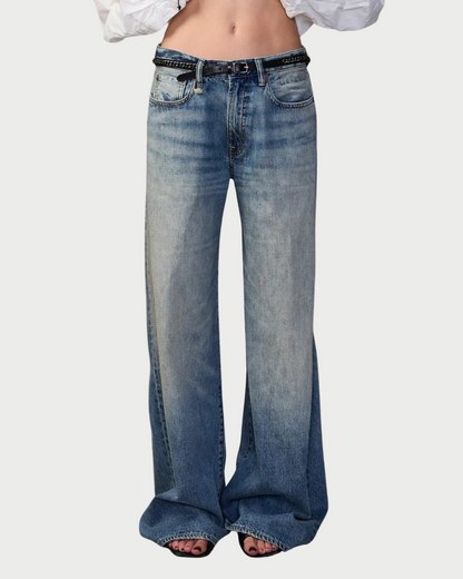 Blue jeans worn by a person on a white background